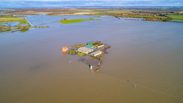 A farm house and barns which have become an island  in Barlings, Lincolnshire. Pic: Geoff Robinson Photography