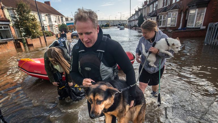 A dog is carried to safety in Doncaster