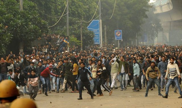 India: Police fire tear gas as protests against new citizenship law turn violent