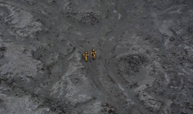 Pictured: Rescue workers scour volcano during body recovery