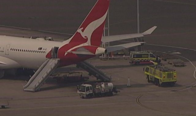 Qantas flight evacuated using slides as cabin starts to fill up with smoke