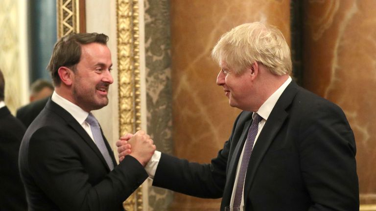 Britain's Prime Minister Boris Johnson (R) greets his Luxembourg counterpart Xavier Bettel at Buckingham Palace in central London on December 3, 2019, to attend reception hosted by Britain's Queen Elizabeth II ahead of the NATO alliance summit. - NATO leaders gather Tuesday for a summit to mark the alliance's 70th anniversary but with leaders feuding and name-calling over money and strategy, the mood is far from festive. (Photo by Yui Mok / POOL / AFP) (Photo by YUI MOK/POOL/AFP via Getty Images)