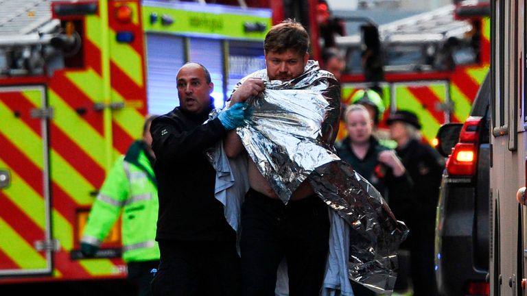 TOPSHOT - Police assist an injured man near London Bridge in London, on November 29, 2019 after reports of shots being fired on London Bridge. - The Metropolitan Police on Friday said several people were injured and a man was held after a stabbing near London Bridge in the centre of the British capital. (Photo by DANIEL SORABJI / AFP) (Photo by DANIEL SORABJI/AFP via Getty Images)