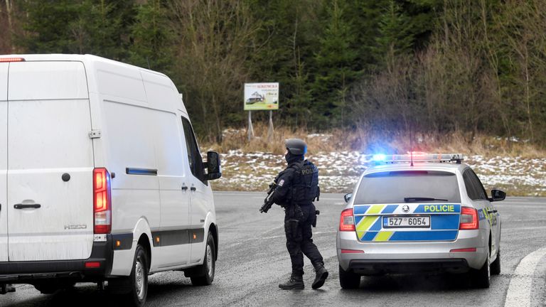 A police officer is seen at a road blockade, as police checks cars after a shooting at Ostrava's University Hospital, near the Slovak-Czech border crossing in Bila, Czech Republic, December 10, 2019. REUTERS/Radovan Stoklasa