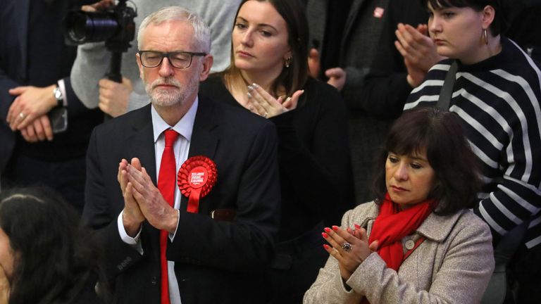 Britain's opposition Labour Party leader Jeremy Corbyn (L) his wife Laura Alvarez  (R) gesture as they wait in the count centre in Islington, north London, on December 13, 2019 as votes are counted as part of the UK general election. - The Conservative Party appeared on course for a sweeping victory in Thursday's snap election, an exit poll showed, pointing toward the best result for the Conservatives since 1987. By contrast, the exit poll spells disaster for the main opposition Labour party which was projected to win just 191 seats -- its worst result since 1935. (Photo by ISABEL INFANTES / AFP) (Photo by ISABEL INFANTES/AFP via Getty Images)