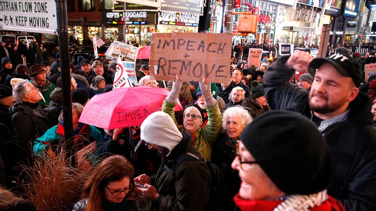 NEW YORK, NEW YORK - DECEMBER 17: Demonstrators join national impeachment demonstrations to demand an end to Donald Trump's presidency named "Nobody Is Above The Law" Rally - NYC at Times Square on December 17, 2019 in New York City. (Photo by John Lamparski/Getty Images for MoveOn.org)