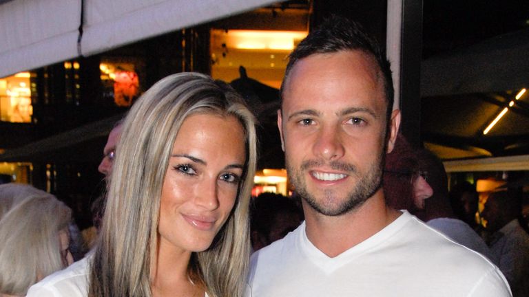 ALTERNATIVE CROP
A picture taken on January 26, 2013 shows Olympian sprinter Oscar Pistorius posing next to his girlfriend  Reeva Steenkamp at Melrose Arch in Johannesburg. South Africa's Olympic sprinter Oscar "Blade Runner" Pistorius was taken into police custody on February 14, 2013, after allegedly shooting dead his model girlfriend having mistaken her for an intruder at his upscale home. AFP PHOTO / WALDO SWIEGERS        (Photo credit should read WALDO SWIEGERS/AFP via Getty Images)