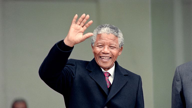 South African anti-apartheid leader and African National Congress (ANC) member Nelson Mandela waves to the press as he arrives at the Elysee Palace, 07 June 1990, in Paris, to have talks with French president Francois Mitterrand. Nelson Mandela, who was released from jail on 11 February 1990, is in Paris for a two-day official visit.        (Photo credit should read MICHEL CLEMENT,DANIEL JANIN/AFP via Getty Images)