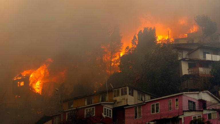 Houses burn during a forest fire at the Rocuant hill in Valparaiso, Chile, on December 24, 2019. - Some 50 houses were affected by a forest fire Tuesday in Valparaiso, where a red alert was declared. (Photo by RAUL ZAMORA / ATON CHILE / AFP) / Chile OUT / RESTRICTED TO EDITORIAL USE - MANDATORY CREDIT "AFP PHOTO / ATON / RAUL ZAMORA " - NO MARKETING NO ADVERTISING CAMPAIGNS - DISTRIBUTED AS A SERVICE TO CLIENTS-CHILE OUT (Photo by RAUL ZAMORA/ATON CHILE/AFP via Getty Images)