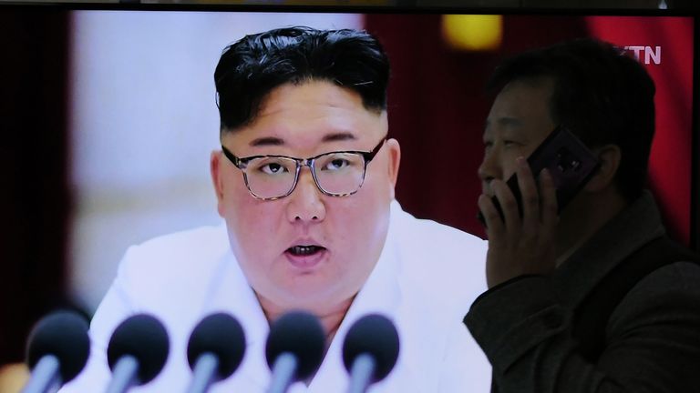 A man walks past a television news program showing the latest pictures of North Korean leader Kim Jong Un, at a railway station in Seoul on December 30, 2019. - North Korean leader Kim Jong Un has called for "offensive measures" to strengthen security ahead of a New Year speech that could flesh out the nuclear-armed nations threat to seek a "new way" forward after the expiration of its year-end deadline for US sanctions relief. (Photo by Jung Yeon-je / AFP) (Photo by JUNG YEON-JE/AFP via Getty Images)