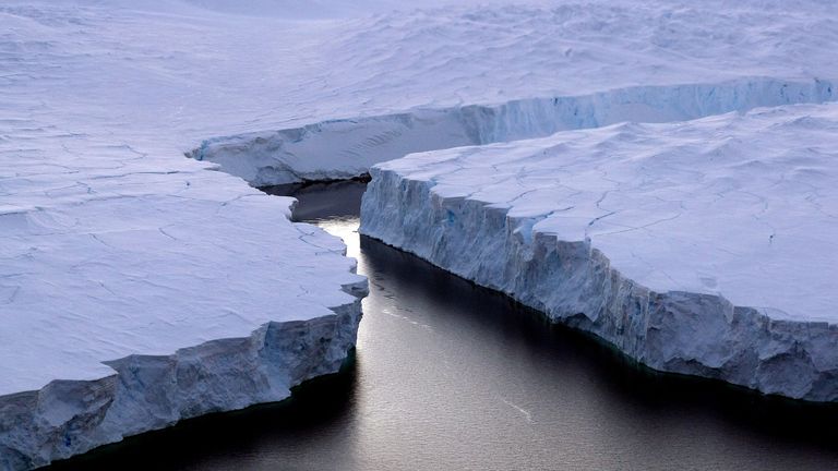 An enormous iceberg (R) breaks off the Knox Coast in the Australian Antarctic Territory