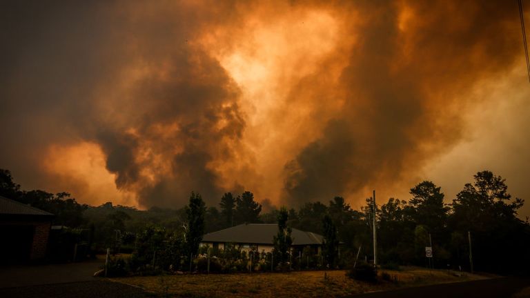 Two bushfires approached a home on the outskirts of the town of Bargo in Sydney