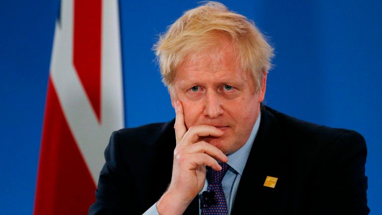 Boris Johnson listens to a question during a press conference at the NATO summit at the Grove hotel in Watford