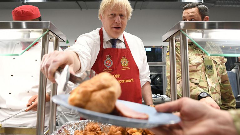Boris Johnson serves Christmas lunch to British troops stationed in Estonia 