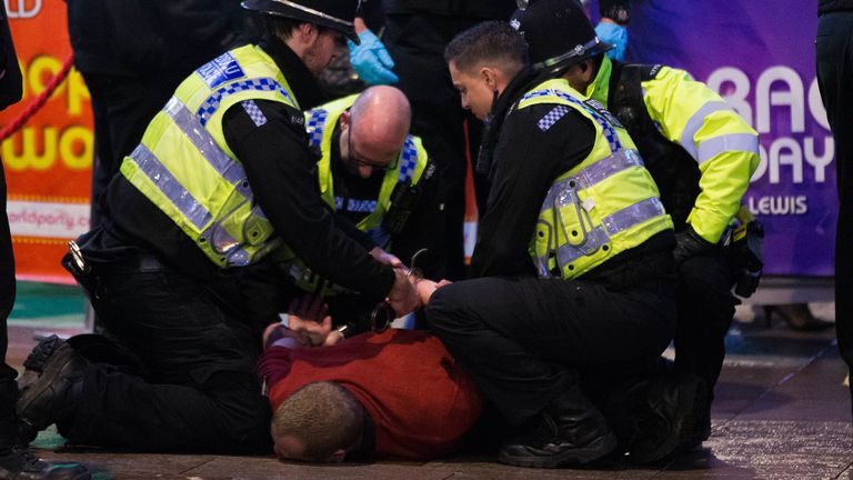 Police make an arrest after a disturbance as revellers in Cardiff make the most of the celebrations on the last Friday before Christmas