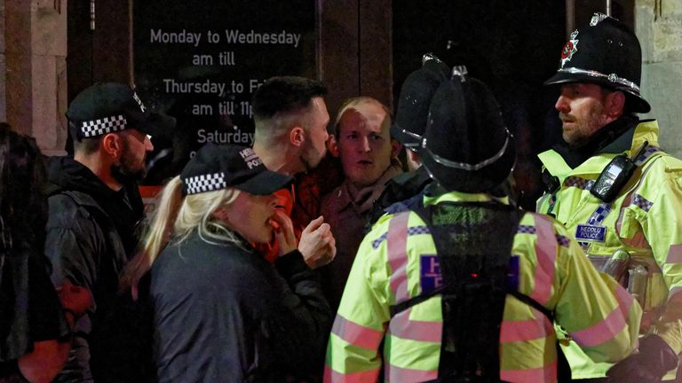 Two men are spoken to by police officers on the last Friday before Christmas IN SWANSEA