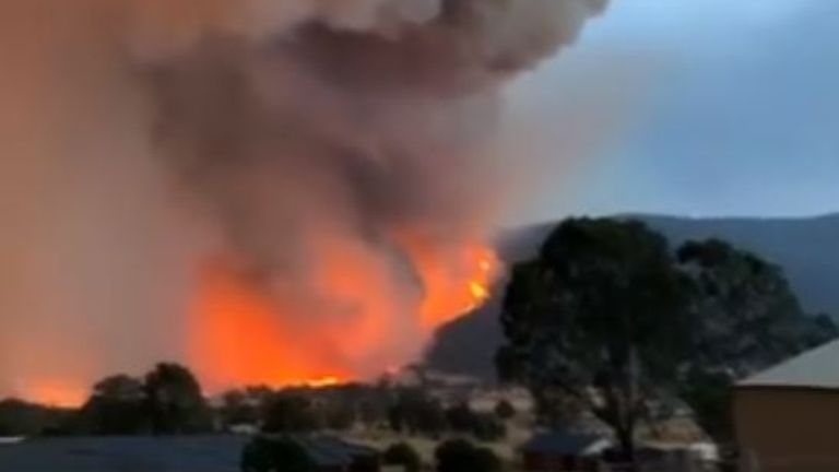 Bushfires threatening the town of Corryong, Victoria, glowed orange in the hills surrounding the municipality on December 31. Pic: Brooke Whitehead via Storyful