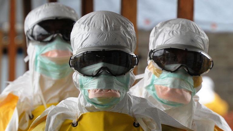 Health care workers leave an Ebola-risk area in Monrovia, Liberia