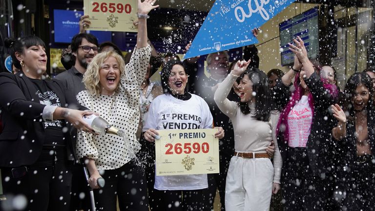 A shop that sold one of the winning tickets celebrates 