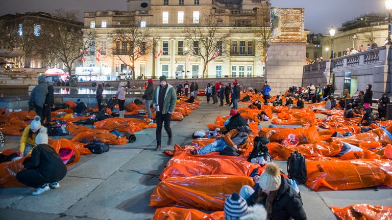 Members of the public sleeping outside overnight in survival bags at Trafalgar Square