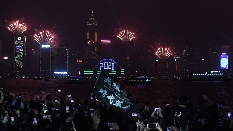 Pro-democracy protesters hold a rally amid a New Year light display in Hong Kong