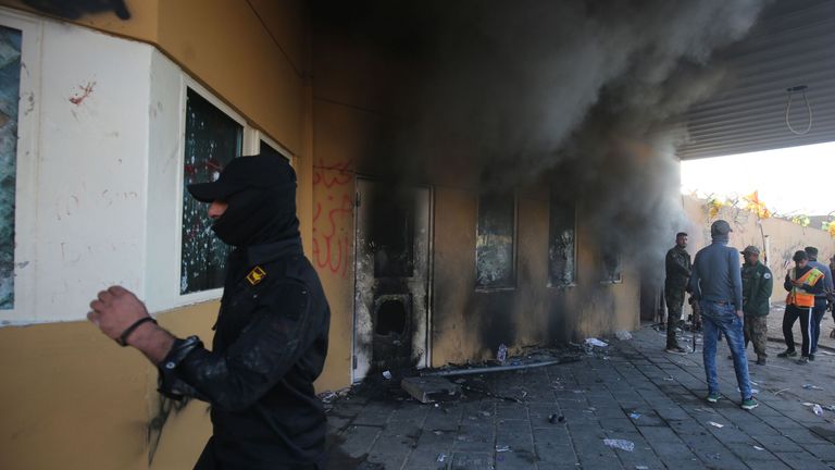 Smoke billows from the entrance of the US embassy in Baghdad after protesters tried to break into the building