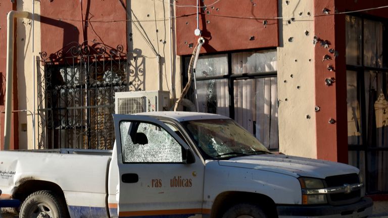 A damaged vehicle after a gunbattle between Mexican security forces and suspected cartel gunmen