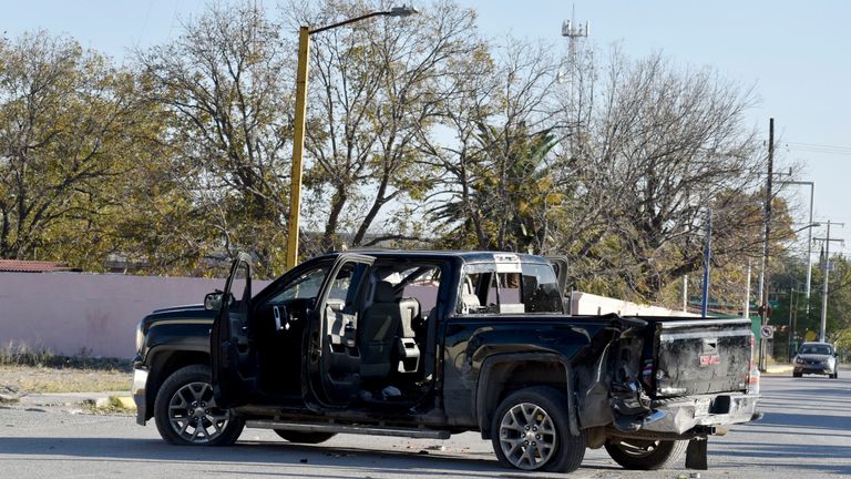 A damaged pick up is on the streets after a gun battle 