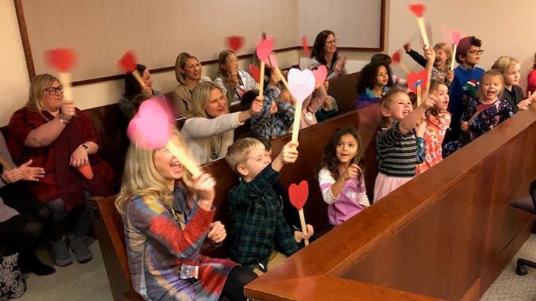 Michael&#39;s friend waved paper hearts when the adoption became official. Pic: Kent County Court