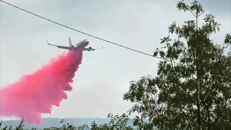 Plane drops red retardant on bushfire in New South Wales