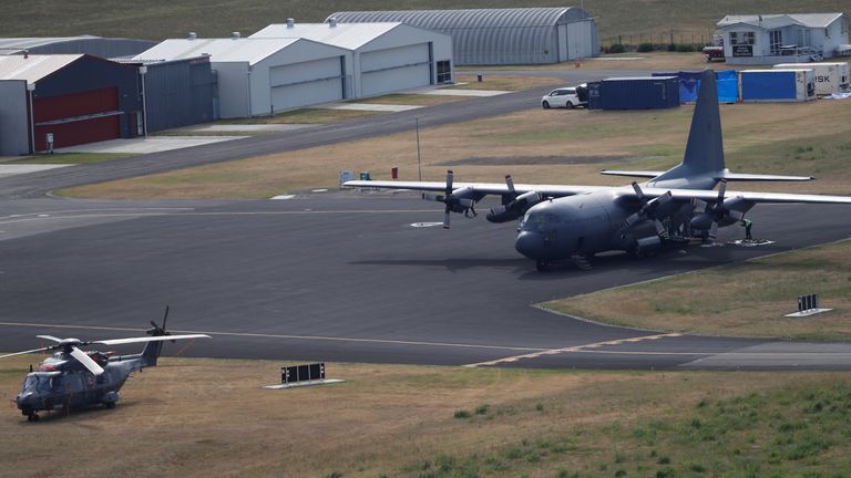 A military plane and helicopter are seen at the airport in Whakatane, New Zealand