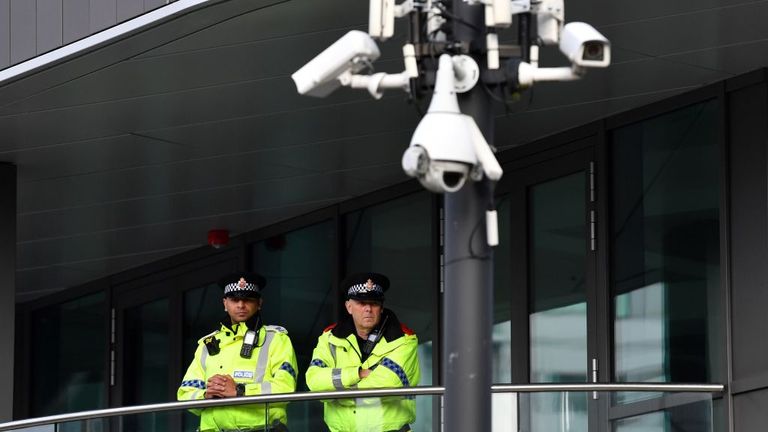British Police officers stand on duty near CCTV cameras on the second day of the annual Conservative Party conference at the Manchester Central convention complex in Manchester, north-west England on September 30, 2019. - British Prime Minister Boris Johnson&#39;s office has denied allegations he made unwanted sexual advances towards two women 20 years ago. Journalist Charlotte Edwardes wrote in a column for The Sunday Times that Johnson put his hand on her thigh at a dinner party thrown by the maga