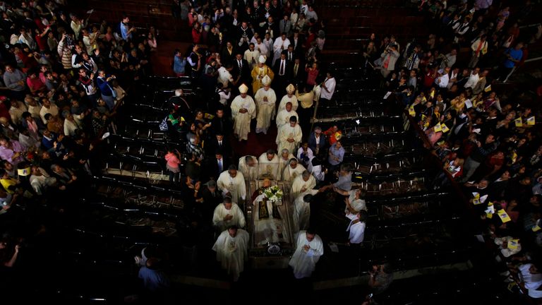 A wax figure of the late pope is carried by members of the Catholic church