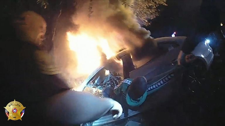 Dramatic moment man pulled from burning car