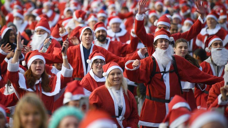 Around 3,000 people dressed in Santa suits dashed around Victoria Park