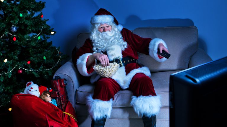 Santa Claus watches some television at Christmas