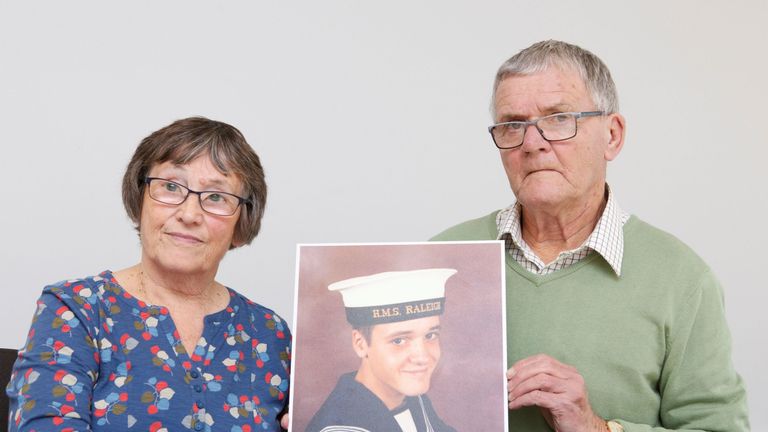 Margaret and David Parkes holding a photograph of their son Simon Parkes,