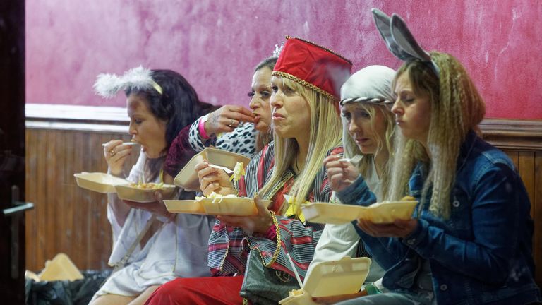 A group of women dressed as characters of the Nativity play, eat a take away meal on the last Friday before Christmas