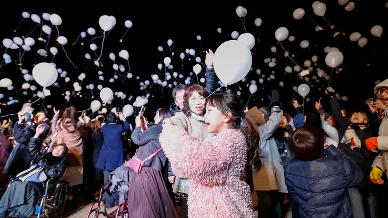 Revellers release balloons during a New Year countdown event in Tokyo

