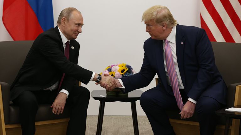 Vladimir Putin and Donald Trump shake hands at the G20 summit in Japan in June 2019