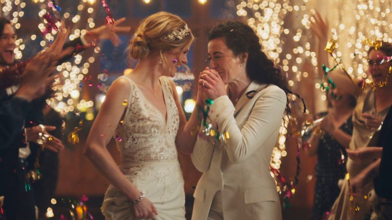 This image made from undated video provided by Zola shows a scene of its advertisement. Under pressure from a conservative advocacy group, The Hallmark Channel has pulled the ads for wedding-planning website Zola that featured same-sex couples, including two brides kissing. 