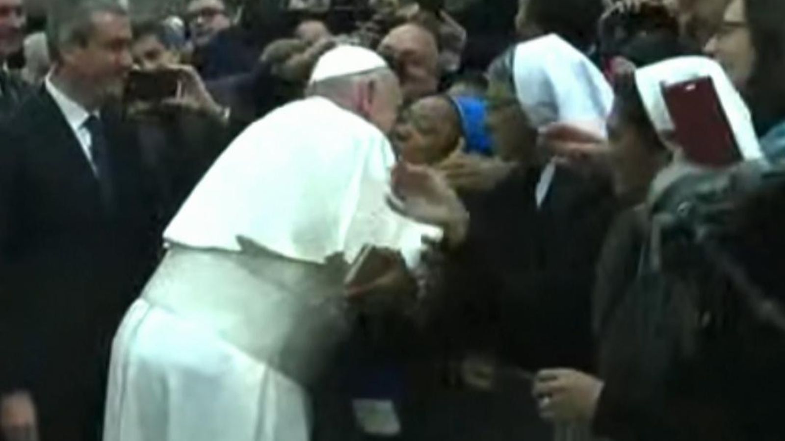 Pope jokes 'don't bite me' before kissing nun World News Sky News