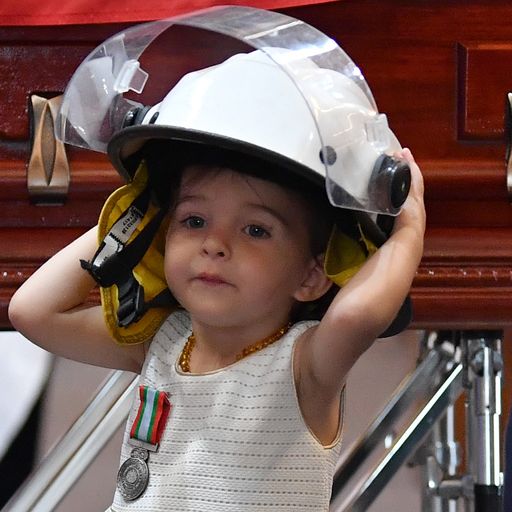 Australia bushfires: Daughter of 'special' firefighter wears his helmet during funeral