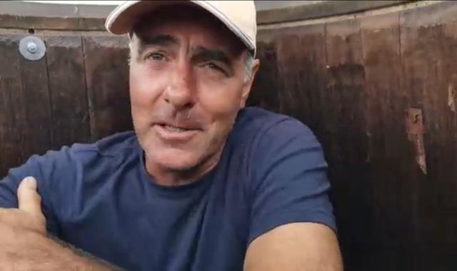 Man breaks own record for... sitting in a barrel at the top of a pole