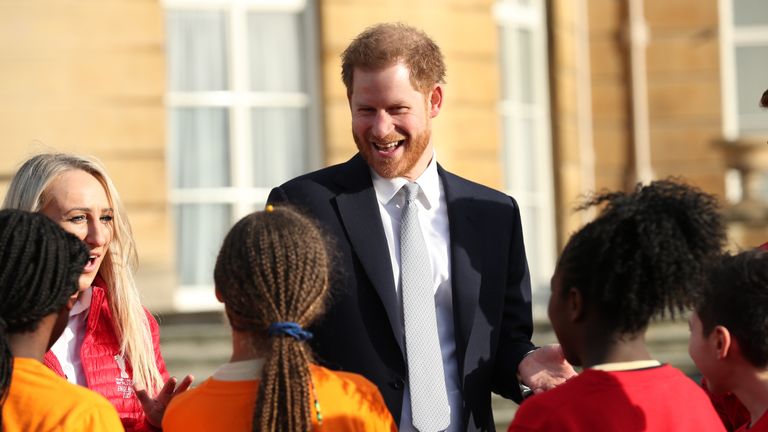 The Duke of Sussex with children playing rugby in the Buckingham Palace gardens, London, as he hosts the Rugby League World Cup 2021 draws.