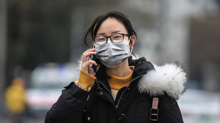 WUHAN, CHINA - JANUARY 17: (CHINA OUT) A woman wears a mask while walking past the closed Huanan Seafood Wholesale Market, which has been linked to cases of Coronavirus, on January 17, 2020 in Wuhan, Hubei province, China. Local authorities have confirmed that a second person in the city has died of a pneumonia-like virus since the outbreak started in December. (Photo by Getty Images)