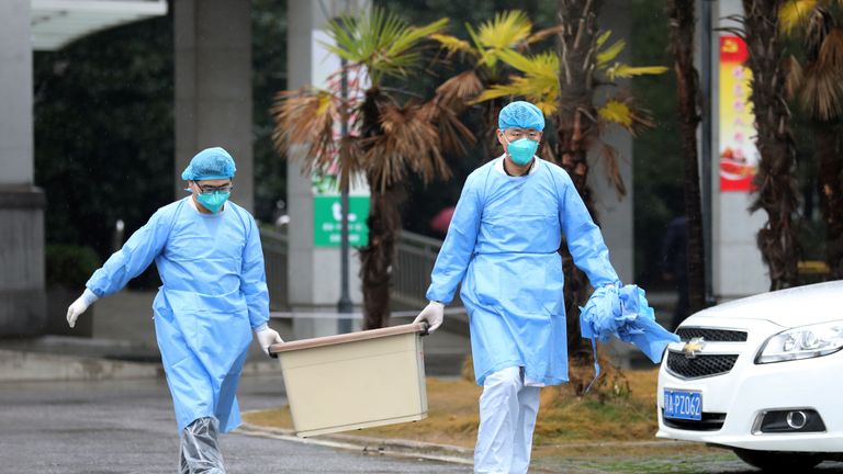 Medical staff carry a box as they walk at the Jinyintan hospital, where the patients with pneumonia caused by the new strain of coronavirus are being treated, in Wuhan, Hubei province, China January 10, 2020. Picture taken January 10, 2020. REUTERS/Stringer CHINA OUT