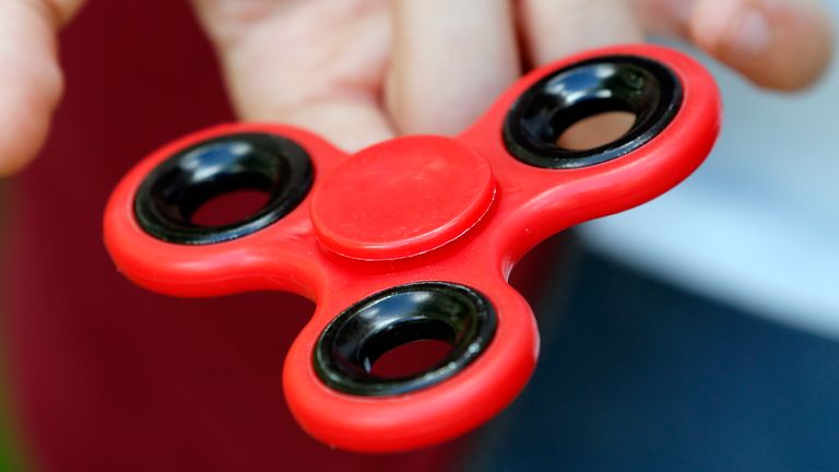 PARIS, FRANCE - MAY 20:  In this photo illustration, a child shows a "Hand Spinner" on May 20, 2017 in Paris, France. The "Hand Spinner" is a toy that sits like a propeller on a person&#39;s finger, with blades that spin around a bearing. Since a month the "Hand spinner" or "Fidget spinner", a whirligig from the United States has become a mondial phenomenon to the point of creating stock shortages in toy stores.  (Photo Illustration by Chesnot/Getty Images)