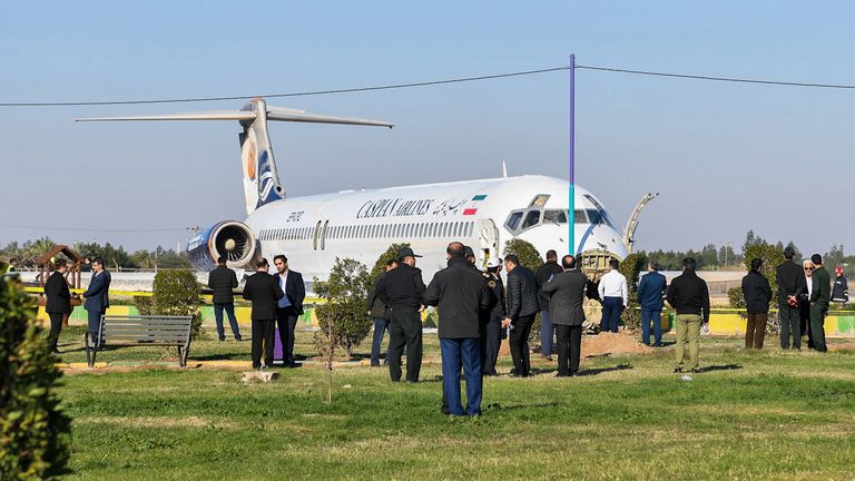 This picture taken on January 27, 2020 in Iran's southwestern city of Bandar-e Mahshahr shows a Caspian Airlines McDonnell Douglas MD-83 aircraft which landed on a highway after it overshot the highway during its approach. No casualties were reported according to state television. - The jet was flying from Tehran's Mehrabad Airport with 135 passengers plus the plane's crew. A state TV reporter travelling on the plane told the broadcaster that the aircraft's "back wheel had broken off, as we saw it was left on the runway" and said the plane had been moving with no wheels before it ground to a halt. (Photo by Mostafa GHOLAMNEZAD / ISNA / AFP) (Photo by MOSTAFA GHOLAMNEZAD/ISNA/AFP via Getty Images)