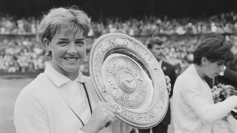 Australian tennis player Margaret Court with her trophy after winning the  Women's Singles title at Wimbledon Championships, All England Lawn Tennis and Croquet Club, London, UK, 4th July 1965. (Photo by Les Lee/Daily Express/Hulton Archive/Getty Images)
